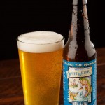A bottle and pint glass of Sweetwater Blue