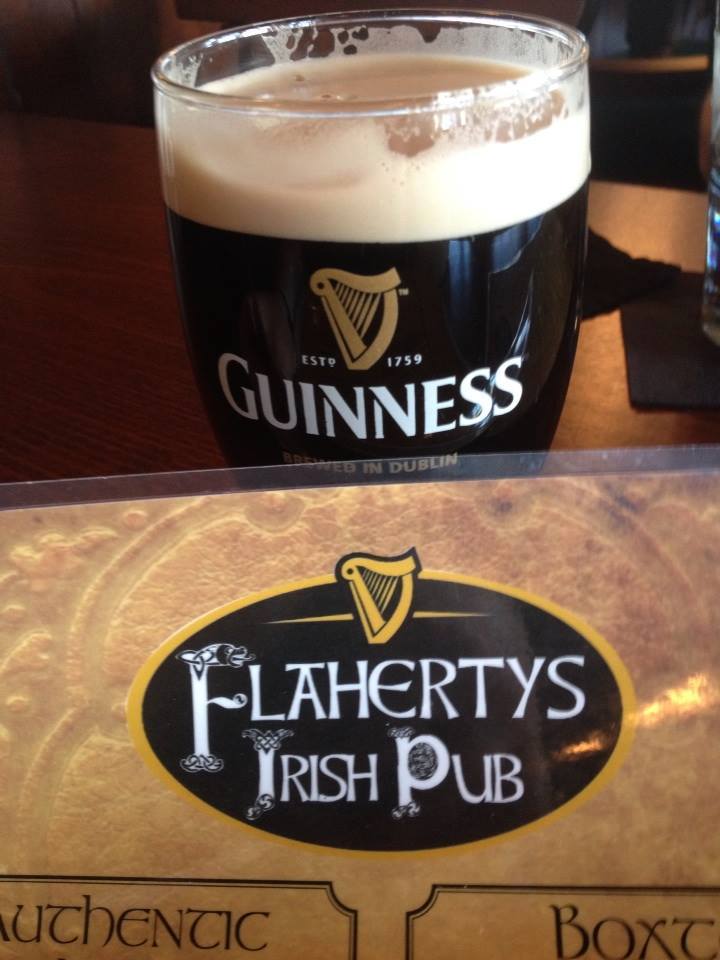 A pint of guiness and a menu from Flaherty's Irish Pub
