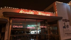 Brent's Drugs store front at night.