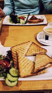 A shot of a quiche and panini with salad at a Brussels cafe.