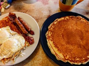 A breakfast spread of pancakes, eggs and sausage at Jim-Denny' in Sacramento