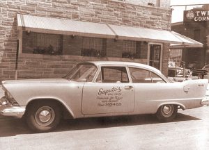 An old picture of a Saputo's delivery car.