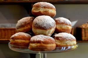 A plate full of paczki donuts.