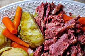 A plate of Irish corned beef and cabbage with carrots.