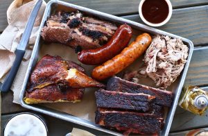 A sheet pan of smoked meats from Bludso's Bar and Que