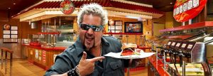 Guy Fieri holding a burger on Carnival Cruise Lines
