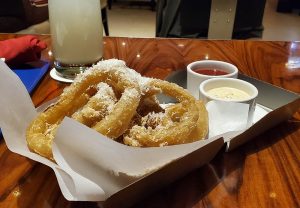 Side of parmesan dusted onion rings.