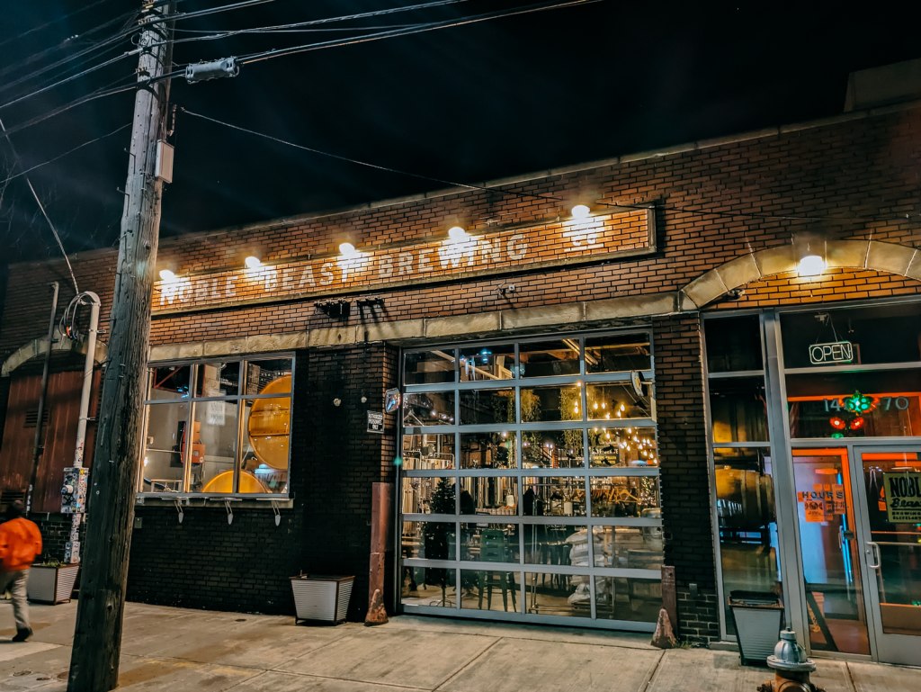 Outside brick building with Noble Beast sign.